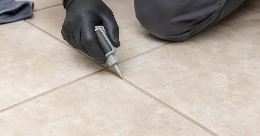 grout color sealing service being applied to floor tile in Ajax